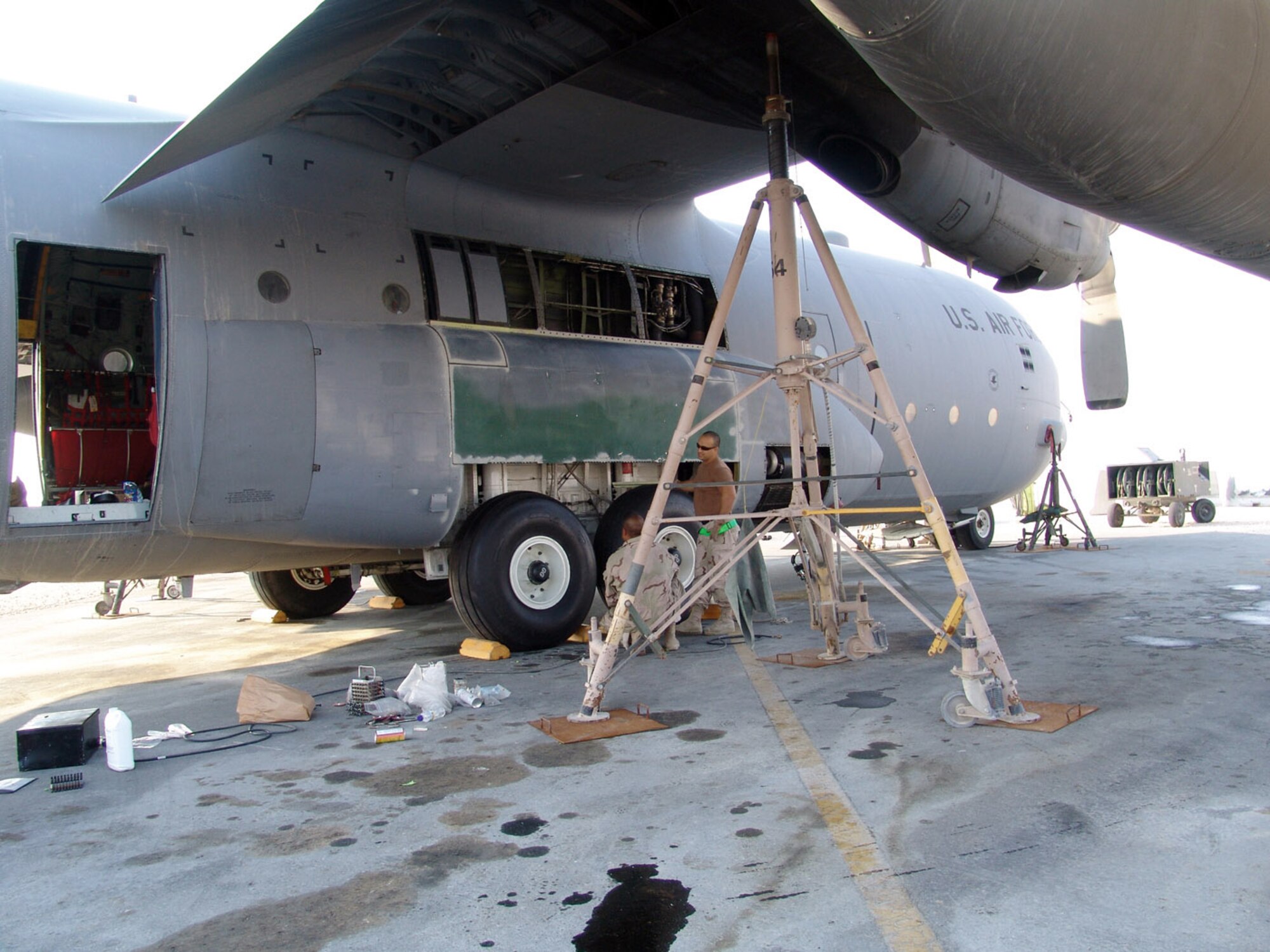 SOUTHWEST ASIA (AFPN) -- Structural repair technicians remove all the damaged parts from a C-130 Hercules before deciding what needs to be replaced. The technicians are with the 379th Expeditionary Maintenance Squadron.  (U.S. Air Force photo)                              