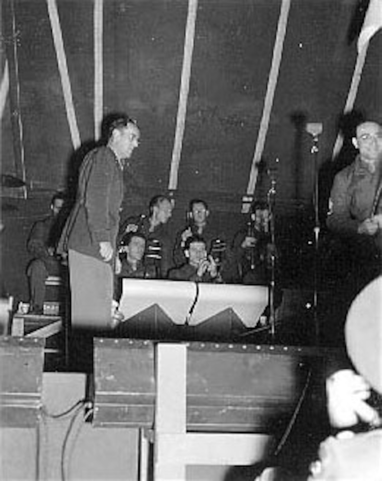 A soldier in the audience takes a photograph of Maj. Glenn Miller as band leader. (U.S. Air Force photo)