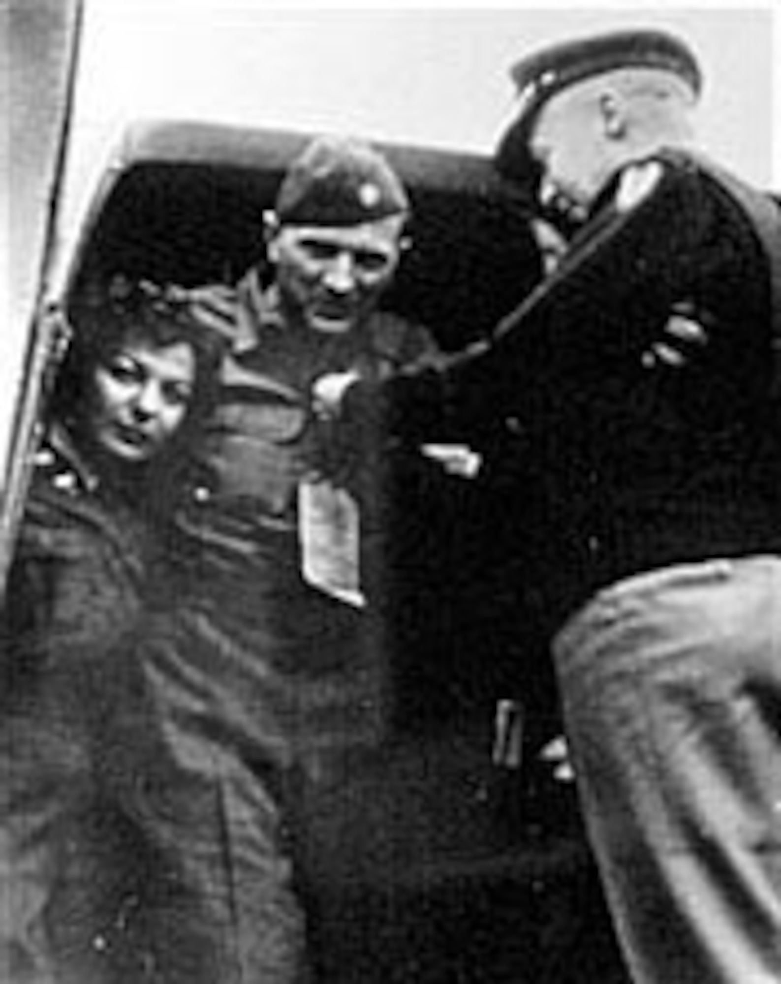 Lt. Col. Michael "Mike" C. Murphy (center), a pre-World War II stunt pilot who later directed the AAF glider pilot training program. He developed new tow techniques, assisted in the planning for the D-Day invasion of France and led the gliders into Normandy. Here, while preparing for medical evacuation to the United States, he received the Purple Heart for injuries suffered in the crash of the glider during the Normandy Invasion. (U.S. Air Force photo)