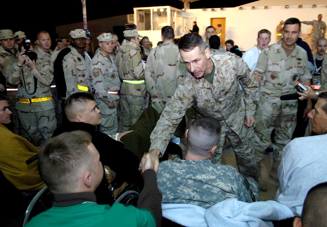 SOUTHWEST ASIA (AFPN) -- Marine Gen. Peter Pace, chairman of the Joint Chiefs of Staff, shakes hands with servicemembers at a desert air base. The general visited the base Dec. 28 while on a tour of the region. (U.S. Air Force photo by Staff Sgt. D. Myles Cullen)