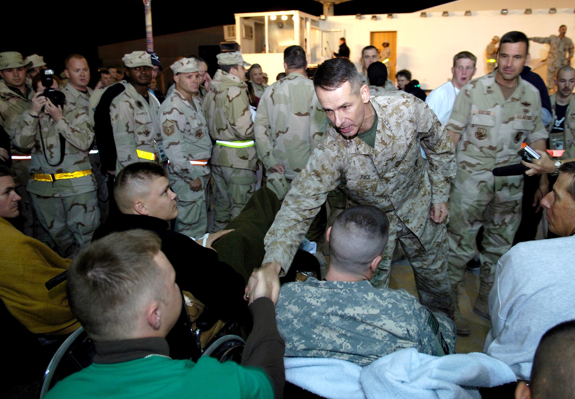 SOUTHWEST ASIA (AFPN) -- Marine Gen. Peter Pace, chairman of the Joint Chiefs of Staff, shakes hands with servicemembers at a desert air base. The general visited the base Dec. 28 while on a tour of the region. (U.S. Air Force photo by Staff Sgt. D. Myles Cullen)