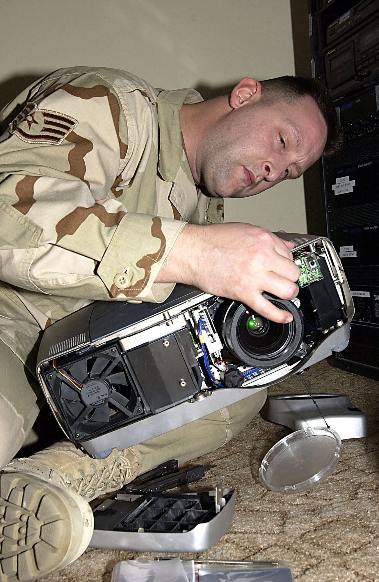 SOUTHWEST ASIA (AFPN) -- Staff Sgt. Ray Josephson troubleshoots a broken projector used here for morale functions. The sergeant is deployed from the 355th Communications Squadron at Davis-Monthan Air Force Base, Ariz. (U.S. Air Force photo by Senior Airman Michael Garza)