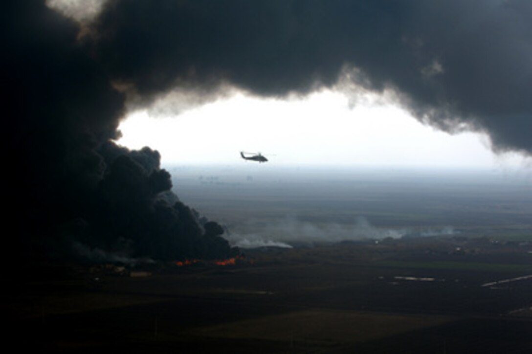 A plume of smoke surrounds a U.S. Army UH-60 Black Hawk helicopter as soldiers of the 101st Airborne Division conduct an aerial assessment of an oil pipeline fire outside Forward Operating Base McHenry, Iraq, on Dec. 27, 2005. Elements of the 101st Airborne Division are deployed to Iraq from Fort Campbell, Ky. 