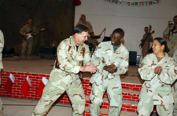 ALI BASE, Iraq (AFPN) -- The U.S. Air Forces in Europe Touch and Go Band had the base "Big Top" hopping and Airmen dancing in the aisles. Gen. William T. "Tom" Hobbins (left) joined in, sharing an impromptu dance with Staff Sgt. Christopher Berry and Tech. Sgt. Marina Moore. General Hobbins is the USAFE commander. Sergeant Berry is deployed to the 407th Expeditionary Communications Squadron and Sergeant Moore to 407th Expeditionary Services Squadron. (U.S. Air Force photo by Tech. Sgt. Paul Dean)