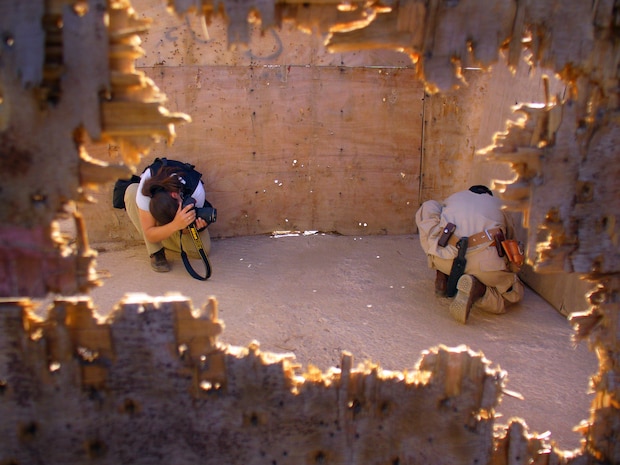 SANA'A, Yemen -- Staff Sgt. Stacy Pearsall documents a Yemeni explosive ordnance disposal technician disabling the blasting cap on a suspicious package during Exercise Western Response training. Sergeant Pearsall is with the 1st Combat Camera Squadron at Charleston Air Force Base, S.C.  (U.S. Air Force photo by Capt. Charles Rohrig)

