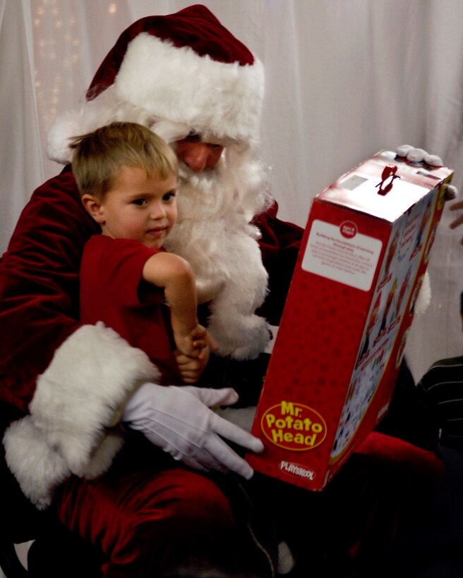 A boy from the village of Kiana, Alaska sits on Santa’s lap as he gets his new toy. This is the first time members of D Company (-) Anti-Terrorism Battalion, 4th Marine Division members assigned to Elmendorf Air Force Base, Alaska personally delivered toys to this region.