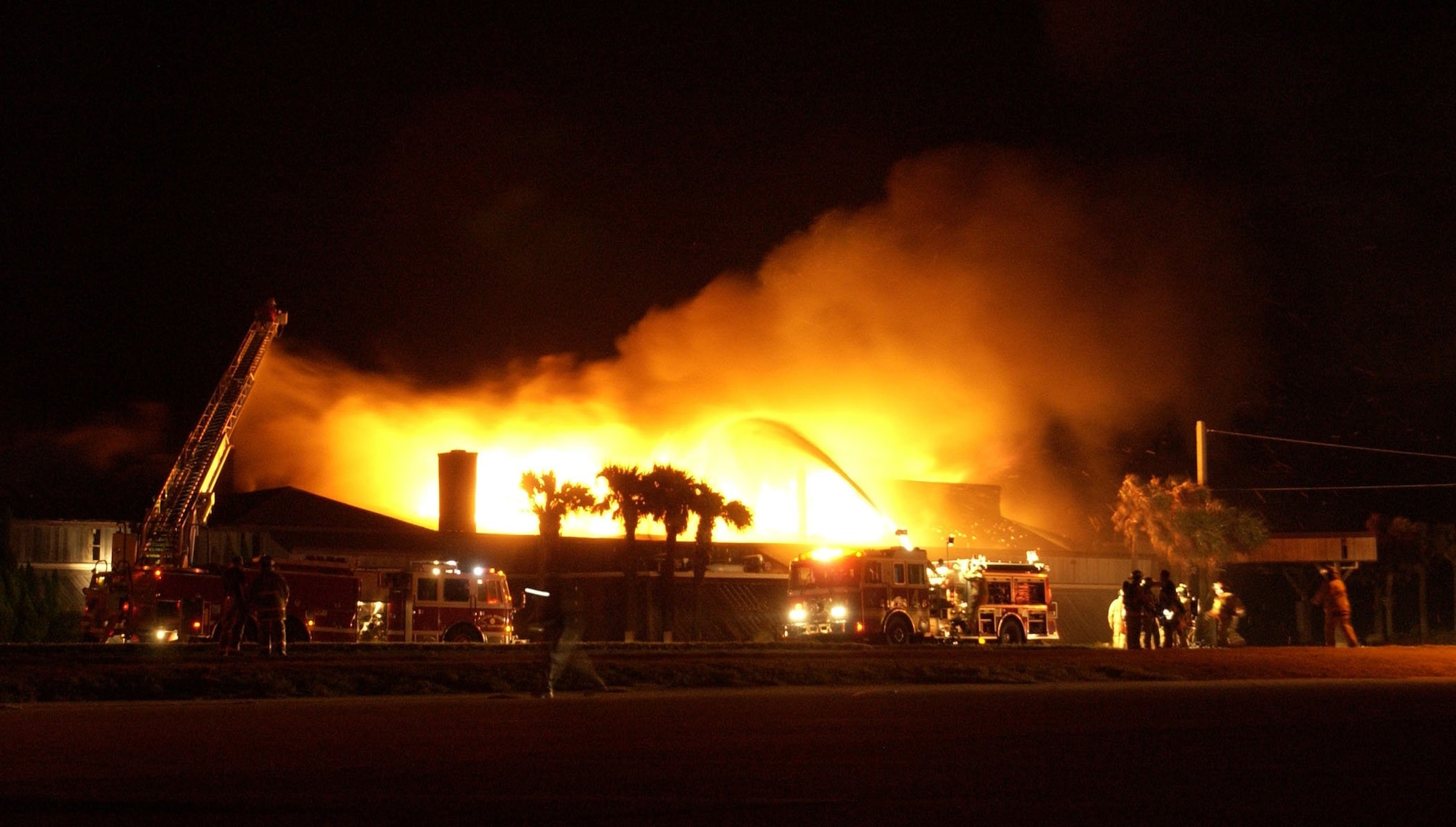 PATRICK AIR FORCE BASE, Fla. -- Firefighters battle flames at the officers club here Jan. 31.  Scores of military and local community firefighters joined in the battle to save the building, but the blaze raged on into the wee hours of the morning and proved to be too strong to extinguish before it destroyed the inside of the structure.  (Courtesy photo by Emily Barnes, Florida Today)