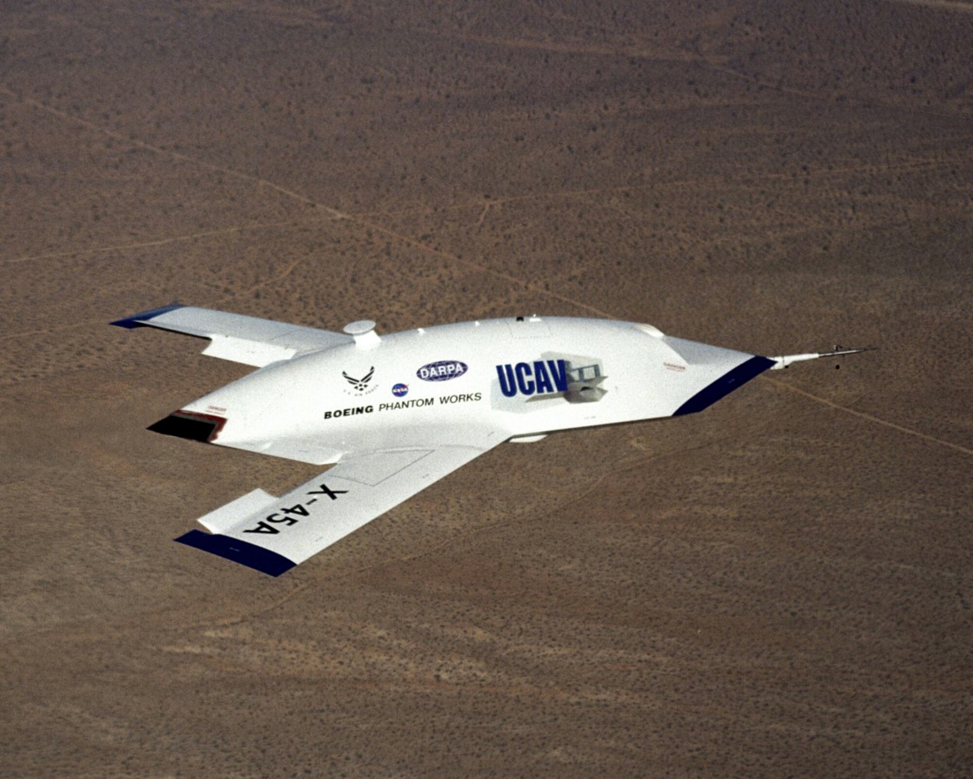 OVER EDWARDS AIR FORCE BASE, Calif. -- An X-45A soars here during a flight to test software upgrades.  The joint-unmanned-combat-air-systems test team demonstrated a transfer of command and control using line-of-sight capabilities Jan. 27, showing a tactical side of the aircraft.  (Photo courtesy of Defense Advanced Research Projects Agency)