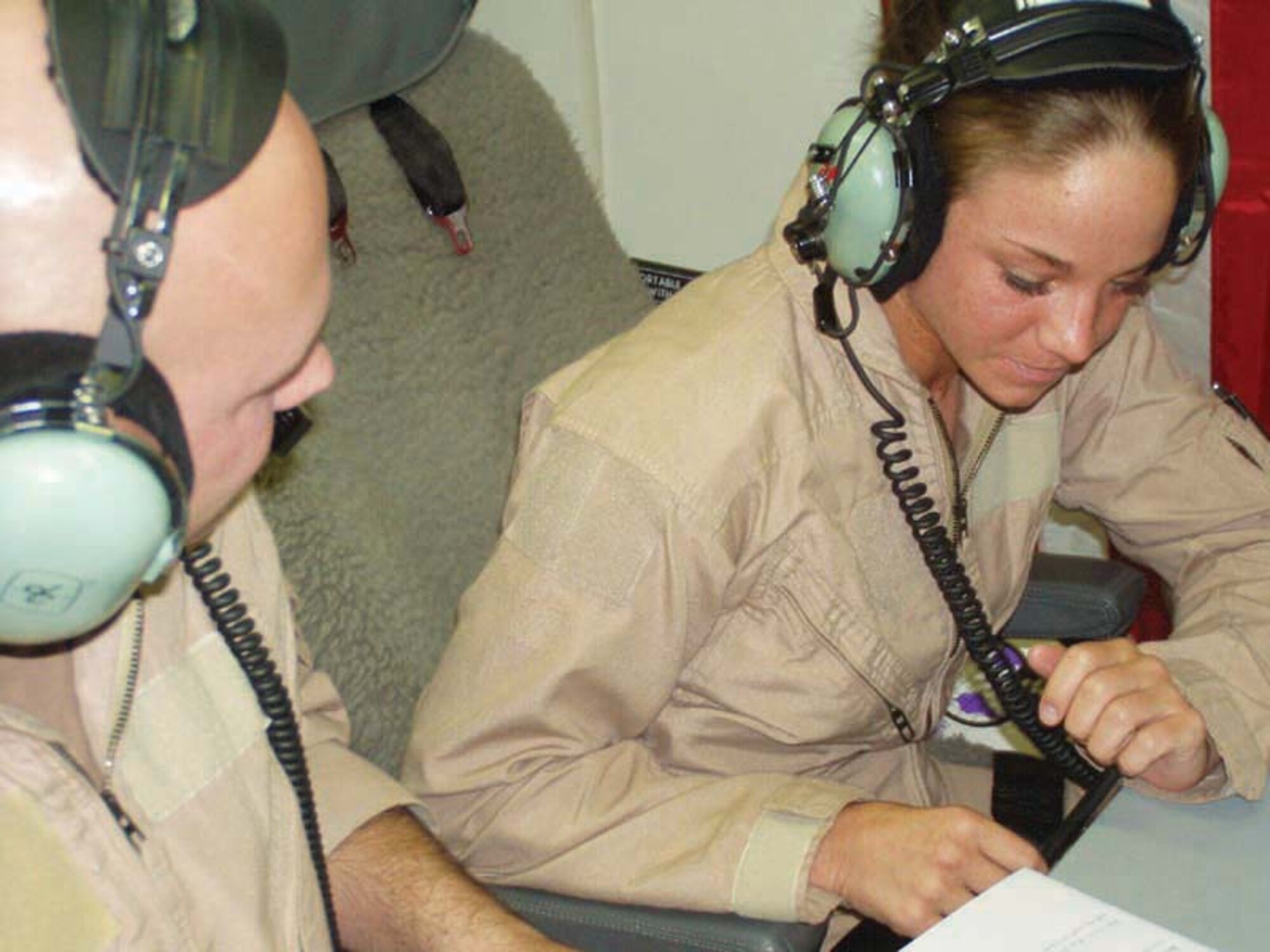 SOUTHWEST ASIA -- Tech. Sgt. Thomas Bloomberg and Airman 1st Class Emily Leece communicate with ground forces more than five miles below them.  They are E-8C Joint STARS air operations technicians with the 379th Air Expeditionary Wing at a forward-deployed location here from Robins Air Force Base, Ga.  (U.S. Air Force photo by Tech. Sgt. Mike Dorsey)