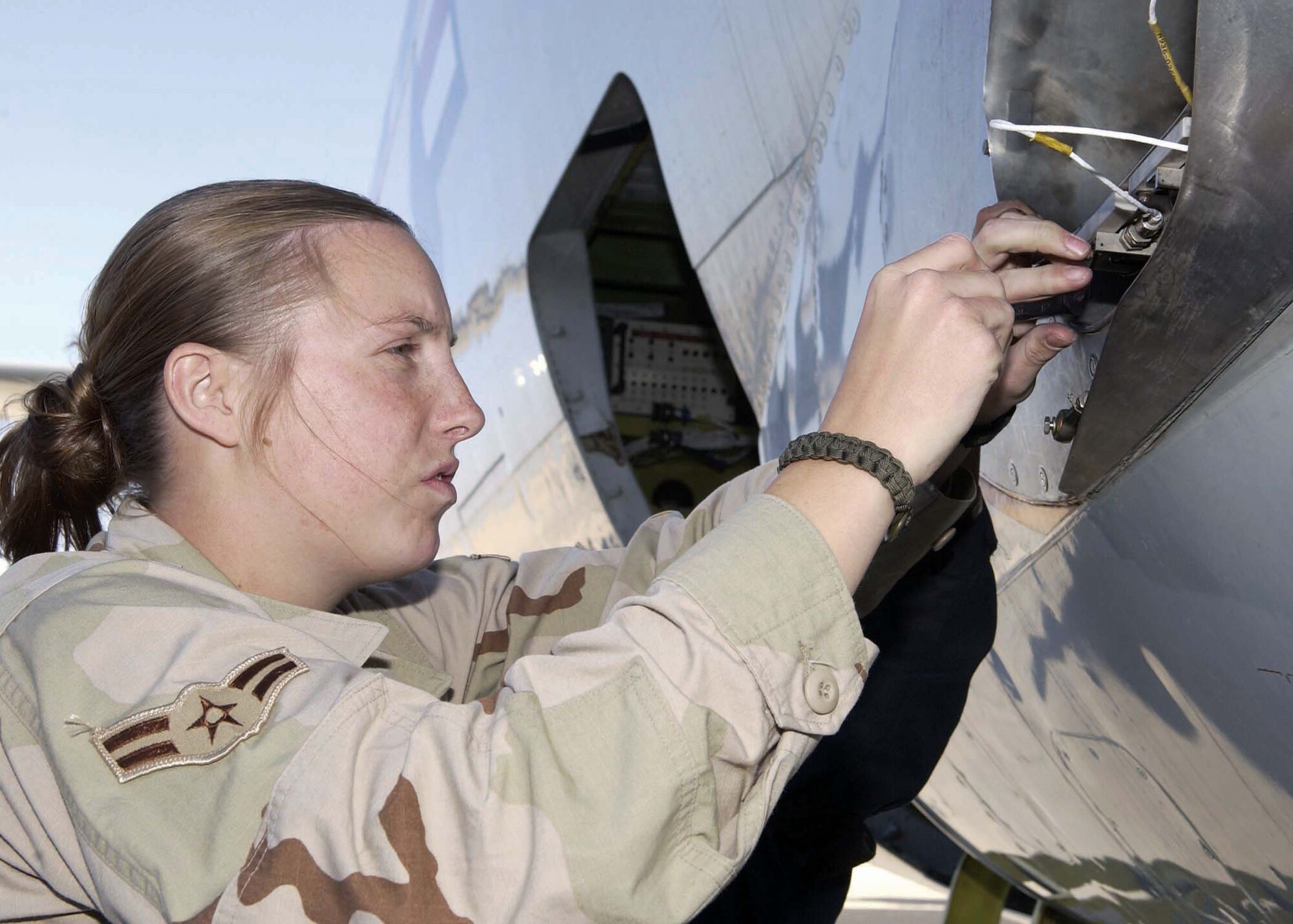 SOUTHWEST ASIA -- Airman 1st Class Michelle Bresson works on an E-8C Joint STARS.  She is an electrical and environmental systems specialist with the 379th Air Expeditionary Wing at a forward-deployed location here from Robins Air Force Base, Ga.  (U.S. Air Force photo by Senior Master Sgt. John P. Snow)