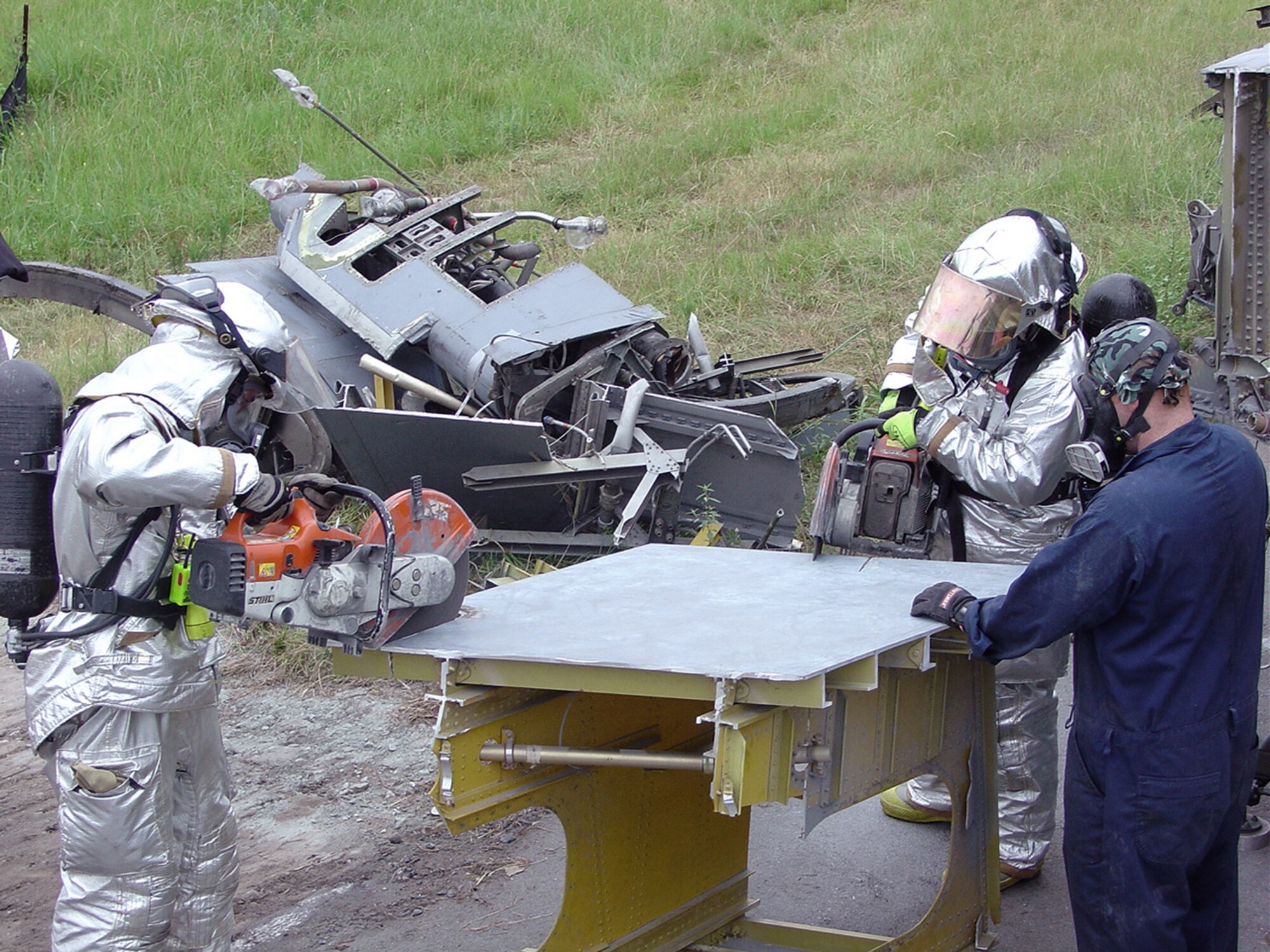ROBINS AIR FORCE BASE, Ga. (AFPN) -- Staff Sgt. Paul Hockaday (right) trains firefighters to use a K-12 cut-saw.  The saws are used by 653rd Combat Logistics Support Squadron Airmen to demilitarize and dismantle aircraft, but are also used in cases of aircraft emergencies.  (U.S. Air Force photo by Tech. Sgt. Rick Gray) 