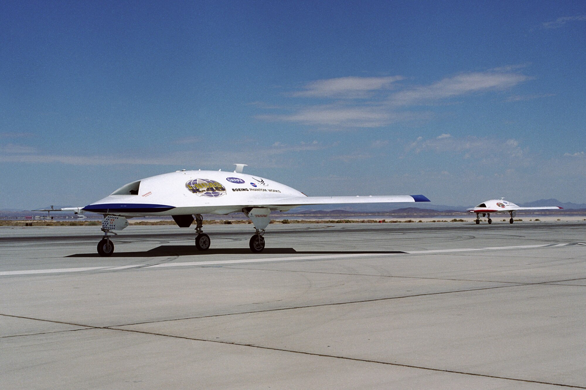 EDWARDS AIR FORCE BASE, Calif. -- Two X-45As taxi after a flight here.  The joint-unmanned-combat-air-systems test team here demonstrated a transfer of command and control using line-of-sight capabilities Jan. 27, showing a more tactical side of the aircraft. (Photo courtesy of Defense Advanced Research Projects Agency)