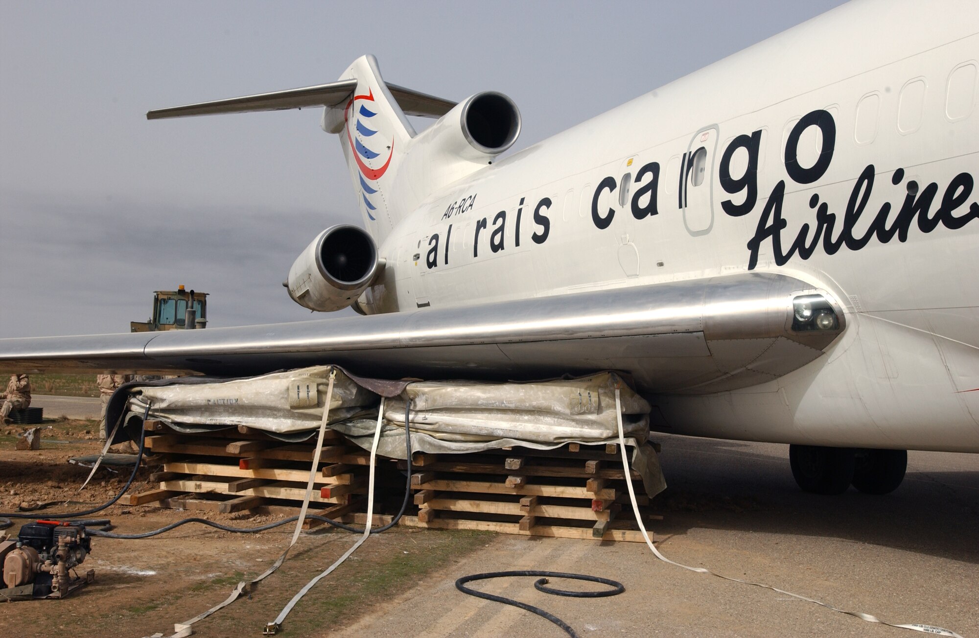 KIRKUK AIR BASE, Iraq -- Airbags were used to raise the wing of the mail cargo plane that was temporarily mired in mud on the edge of a taxiway here.  The airbags are capable of lifting 12 tons of weight.  (U.S. Air Force photo by Staff Sgt. Matthew Lohr)