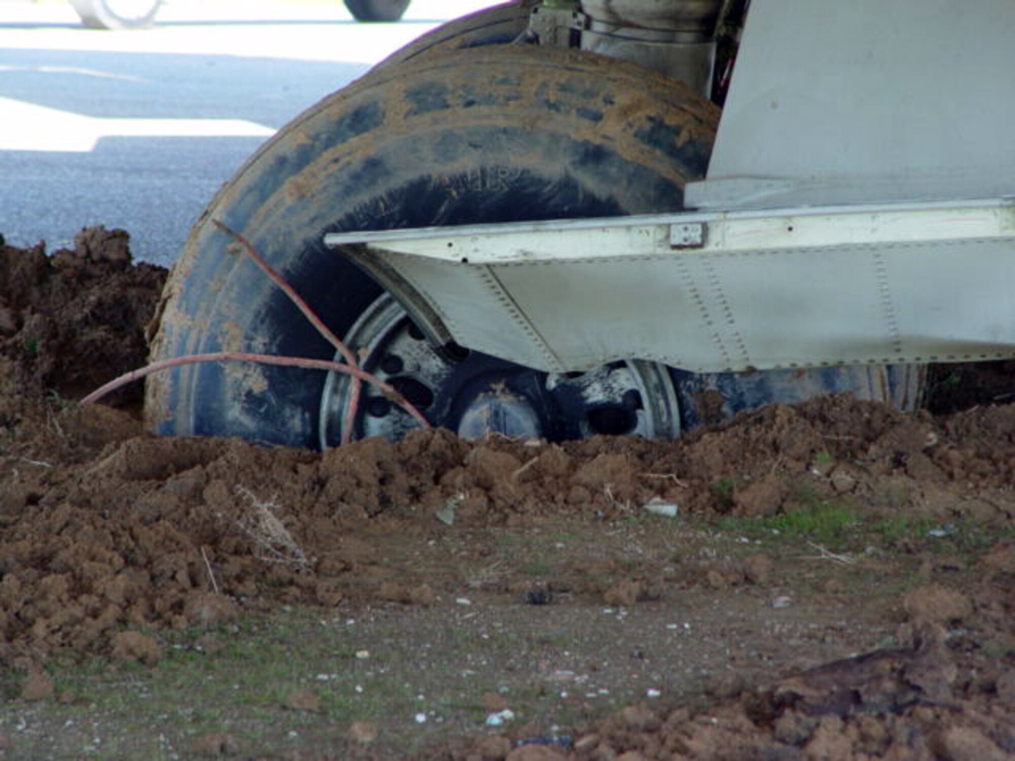 KIRKUK AIR BASE, Iraq -- A mail cargo plane taxing here turned too soon and became mired in about two-and-a-half feet of mud.  The aircraft was stuck between two taxiways while Airmen spent more than 40 hours removing it.  (U.S. Air Force photo by Staff Sgt. Matthew Lohr)