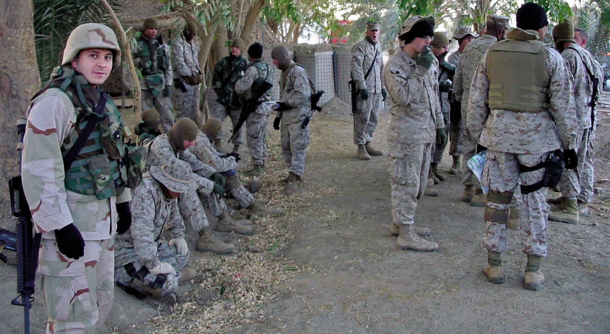 IRAQ -- First Lt. Ed Ruckwardt and other members of the 1st Marine Expeditionary Force take a break after sweeping an area. The lieutenant's primary job is to purchase items for the Iraqi security forces in the western portion of the country.  He is deployed from 82nd Contracting Squadron at Sheppard Air Force Base, Texas.  (Courtesy photo)
