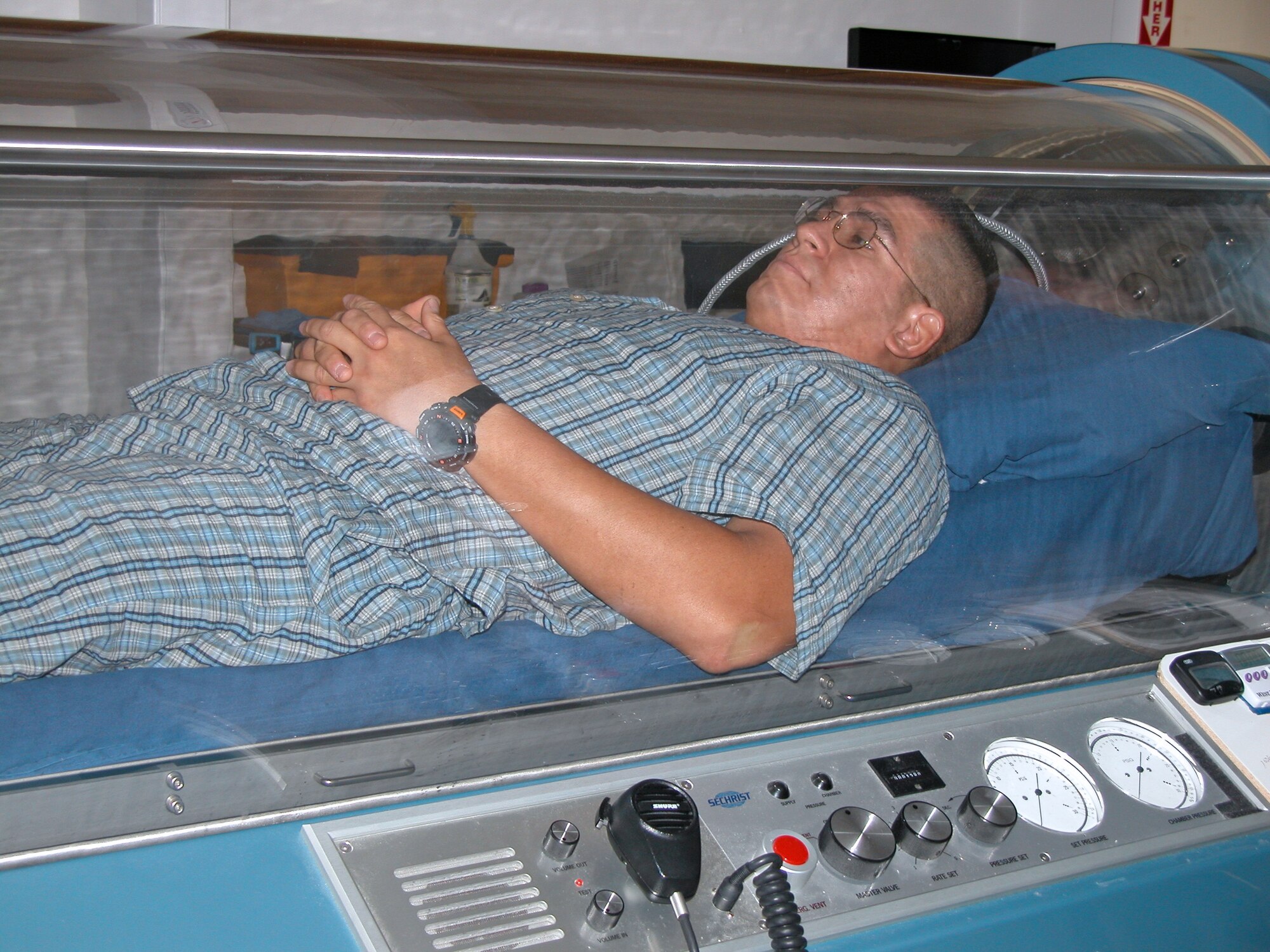EGLIN AIR FORCE BASE, Fla. -- Tech. Sgt. Hector Barrios receives hyperbaric-oxygen therapy in September 2003 to treat a foot injury he received while deployed supporting Operation Iraqi Freedom.  Sergeant Barrios faced an 18-month struggle of amputation, reconstruction and infections before he gained medical clearance to remain in the Air Force.  Sergeant Barrios is a dog handler with the 96th Security Forces Squadron here.  (U.S. Air Force photo by Lois Walsh)