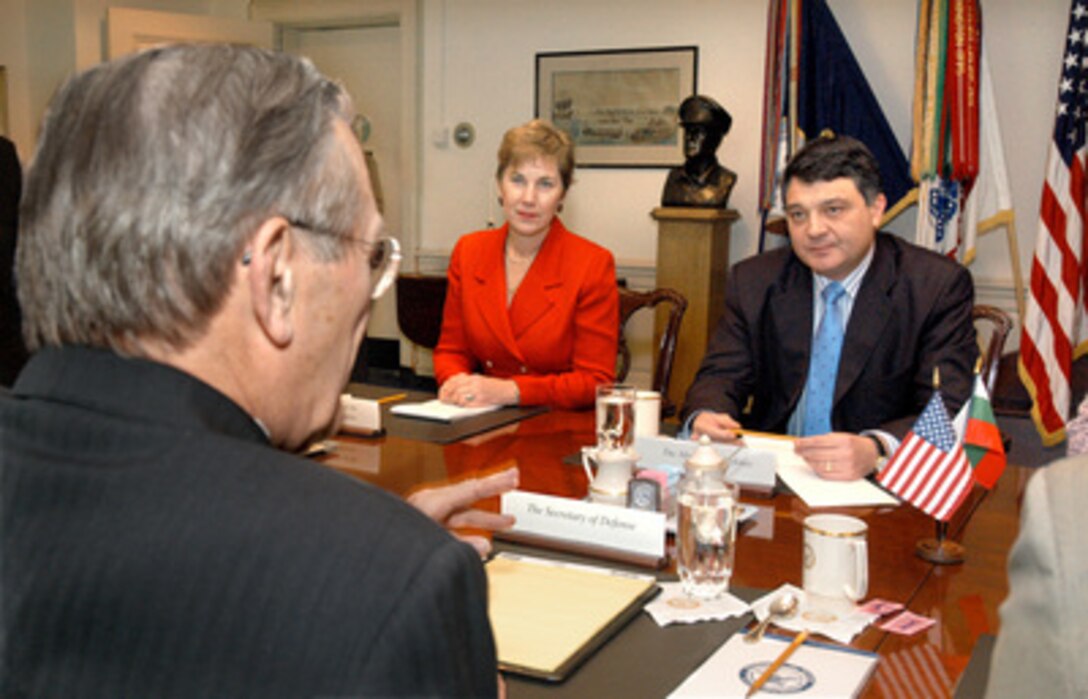 Bulgarian Minister of Defense Nikolai Svinarov (right) meets with Secretary of Defense Donald H. Rumsfeld (foreground) in the Pentagon on Feb. 3, 2005. Svinarov, Rumsfeld and the Bulgarian Ambassador to the United States Elena Poptodorova (center) are meeting to discuss a range of security issues of mutual interest. 