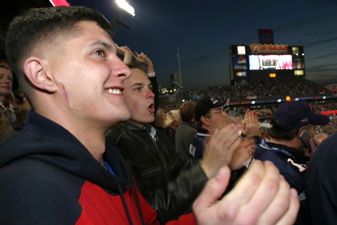 Lance Cpl. Michael Berninger, motor transport driver, 2nd Radio battalion, and Lance Cpl. Conrad Carson, vehicle commander, 3rd battalion 2nd Marine regiment, cheer during a pre-game tribute to the military at Super Bowl XXXIX. The Cleveland Browns donated approximately 30 tickets to Marines of the II Marine Expeditionary Force.