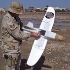 TALLIL AIR BASE, Iraq -- Staff Sgt. James Ellis adjusts the camera in a Desert Hawk here Jan. 26.  The Desert Hawk is a miniature unmanned aerial vehicle used by security forces to see beyond base perimeters providing a rapid assessment of threats.  (Courtesy photo)