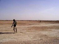 TALLIL AIR BASE, Iraq -- Master Sgts. John Jackson (Left) and Tyrone McKay launch a Desert Hawk here.  The Desert Hawk is a miniature unmanned aerial vehicle used by security forces to see beyond base perimeters providing a rapid assessment of threats.  (Courtesy photo)