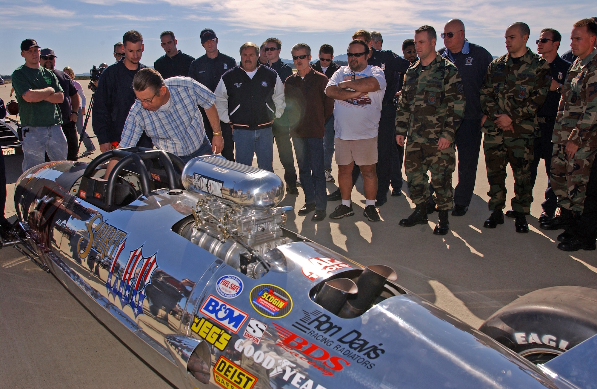 VANDENBERG AIR FORCE BASE, Calif. -- Al Teague gives the Belly Tank Lakester a last-minute inspection before Jesse James, from the TV show "Monster Garage," races it down the runway here.  Cameras captured Mr. James and the car recently during several speed runs for an upcoming show.  The car was made out of a drop tank from an F-4 Phantom.  Mr. Teague is a member of the team that built the car.  (U.S. Air Force photo by Senior Airman Karlonia Gmyrek) 