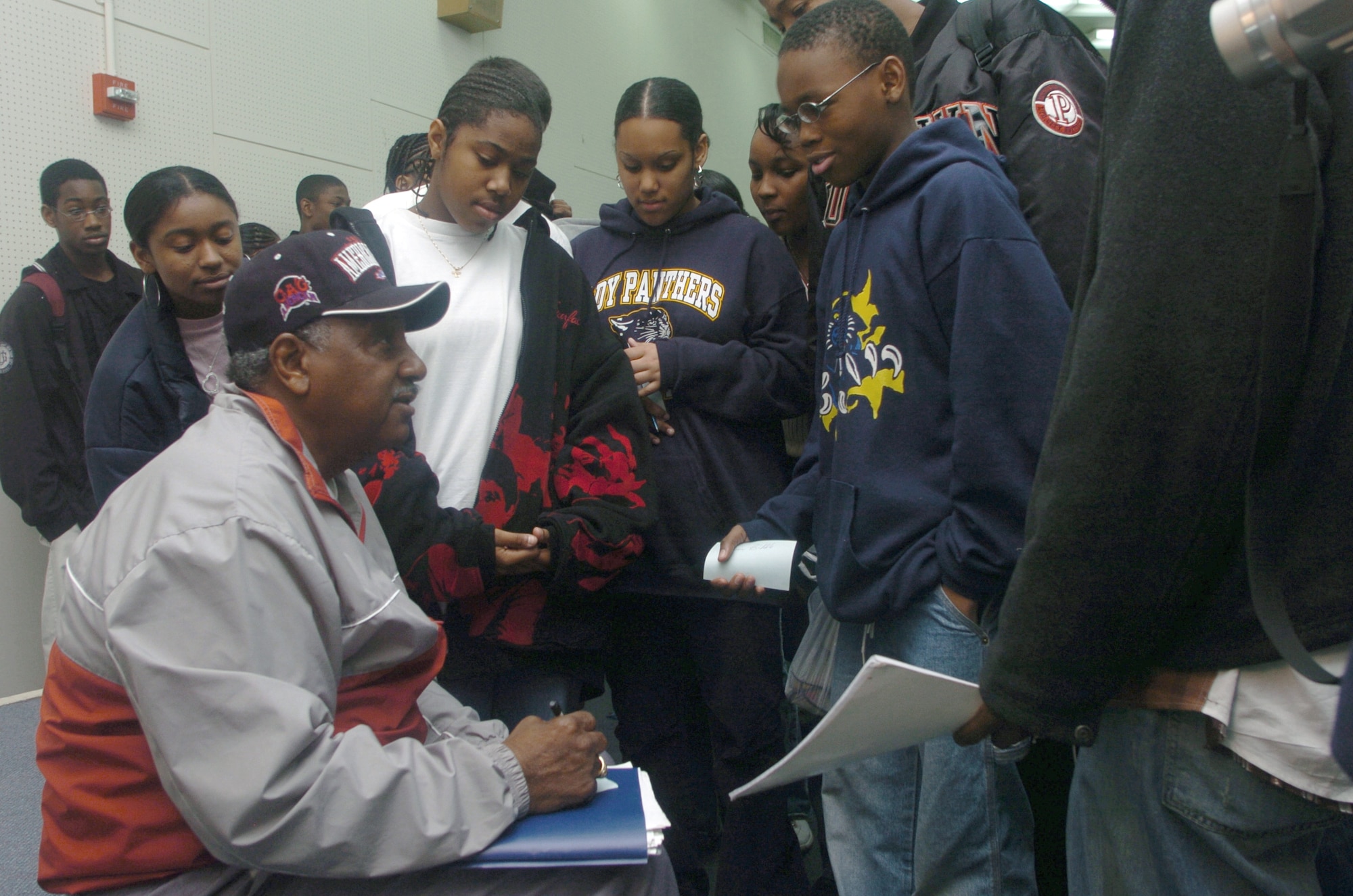 YOKOTA AIR BASE, Japan -- Dennis Biddle, a former Negro Baseball League star, signs autographs for high school students during his visit here.  Mr. Biddle shared the unwritten story of the league at various schools and organizations during his 10-day visit to Japan.  (U.S. Air Force photo by Master Sgt. Val Gempis) 