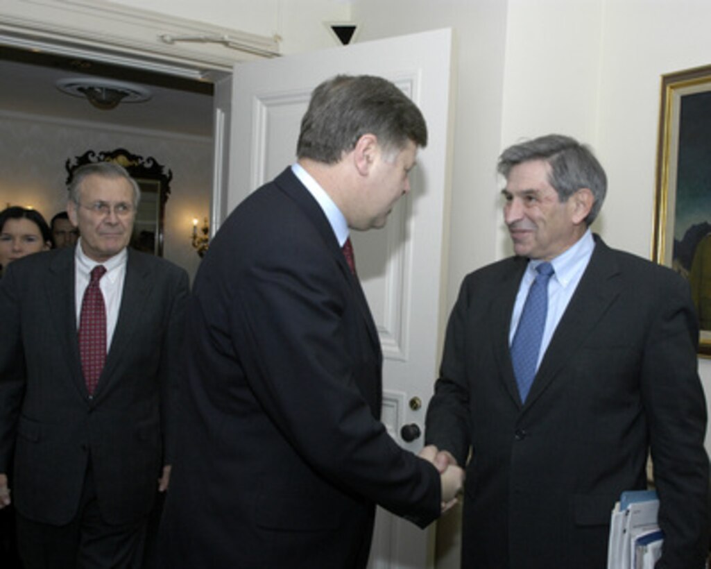 Deputy Secretary of Defense Paul Wolfowitz (right) greets Poland's Minister of Defense Jerzy Szmajdzinski (center) in the Pentagon on Feb. 8, 2005. Szmajdzinski was escorted by Secretary of Defense Donald H. Rumsfeld (left) to their meeting on defense issues of mutual interest. 