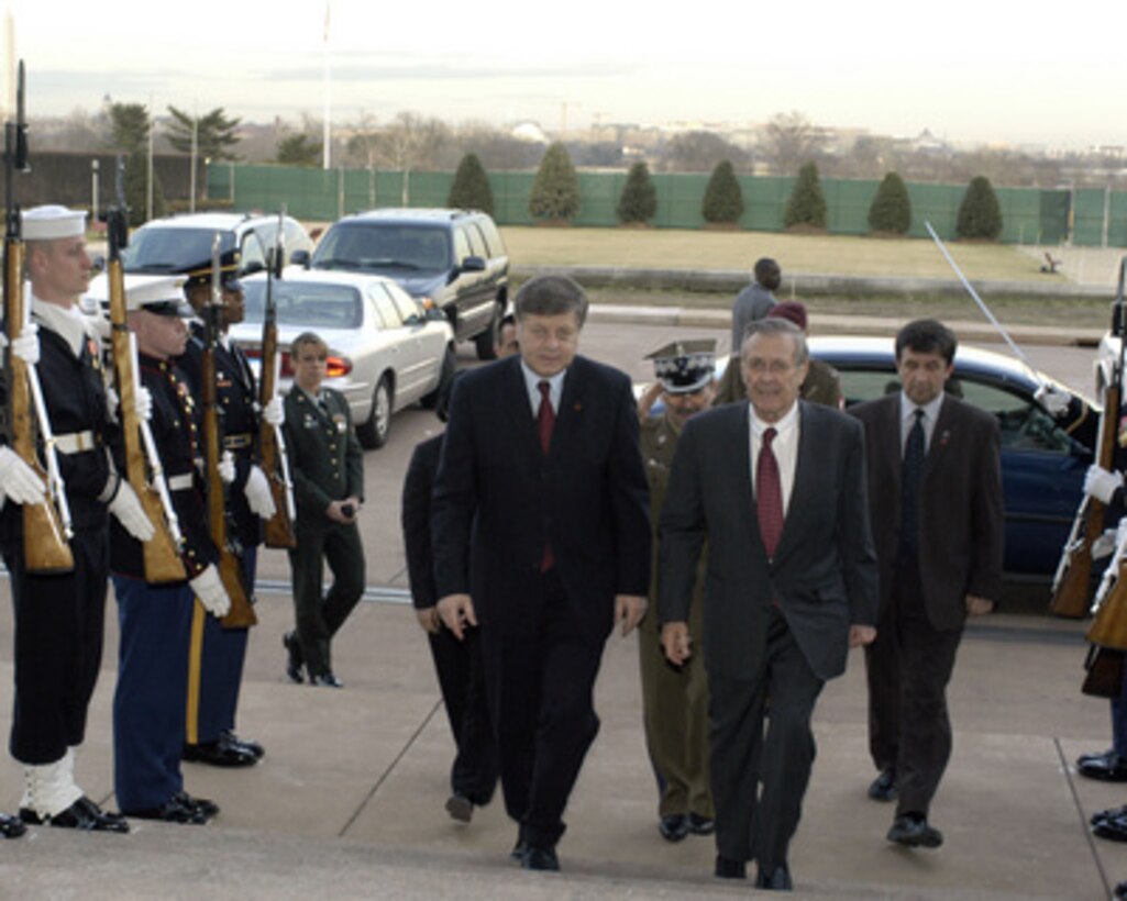 Secretary of Defense Donald H. Rumsfeld (right) escorts Poland's Minister of National Defense Jerzy Szmajdzinski (left) through an honor cordon and into the Pentagon on Feb. 8, 2005. Rumsfeld and Szmajdzinski will meet to discuss defense issues of mutual interest. 