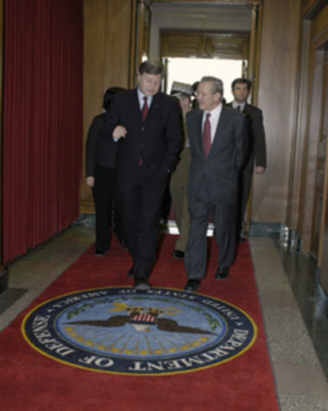 Secretary of Defense Donald H. Rumsfeld (right) escorts Poland's Minister of National Defense Jerzy Szmajdzinski (left) into the Pentagon on Feb. 8, 2005. Rumsfeld and Szmajdzinski will meet to discuss defense issues of mutual interest. 
