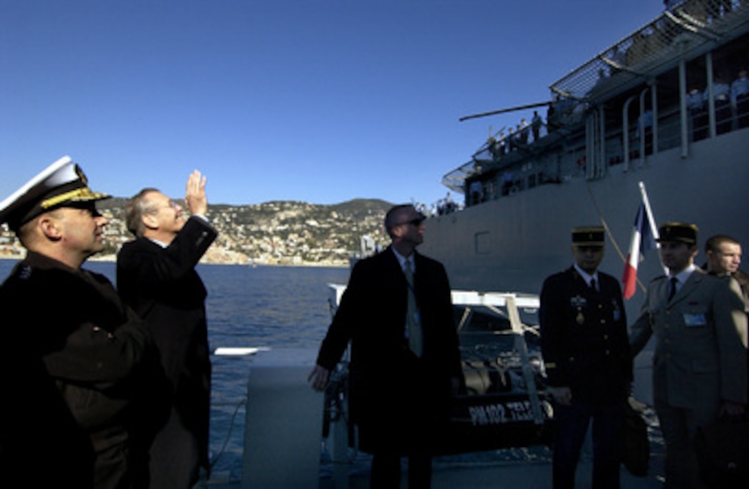 Secretary of Defense Donald H. Rumsfeld waves to the crew of the USS O'Bannon (DD 987) as he leaves the ship lying at anchor off the coast of Nice, France, on Feb. 9, 2005. Rumsfeld visited the Spruance class destroyer to speak to the crew and present various awards including Sailor and Shiphandler of the year. The Defense Secretary is in Nice to attend a conference with NATO Ministers of Defense. 