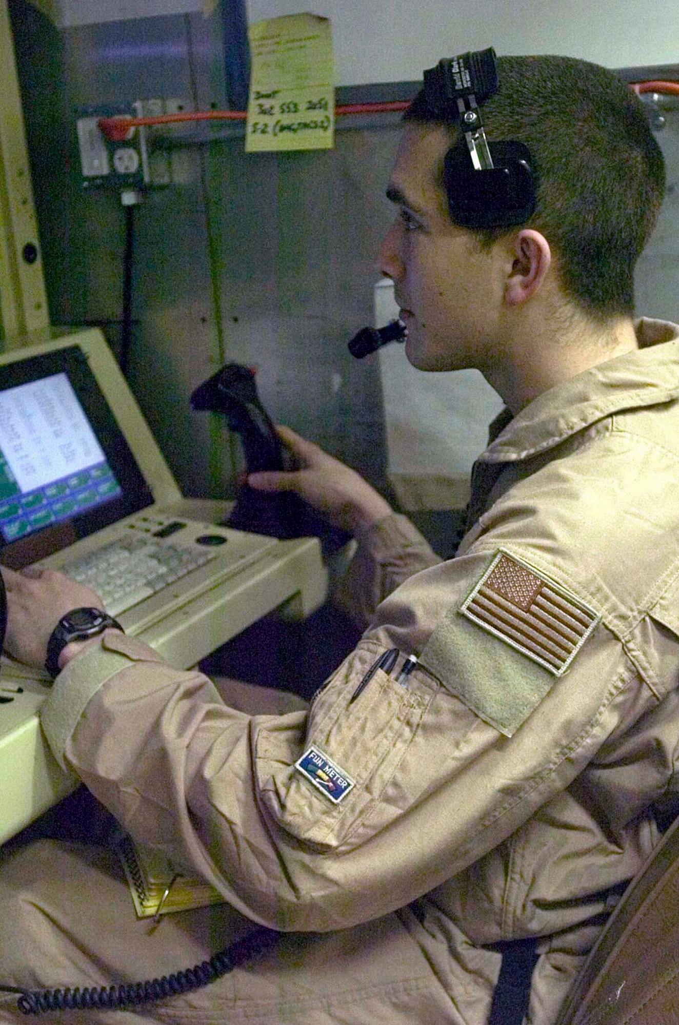 BALAD AIR BASE, Iraq -- Airman 1st Class Tyler Farley controls the virtually undetectable RQ/MQ-1 Predator unmanned aerial vehicle's cameras from his seat on the ground.  Airman Farley is a sensor operator.  (U.S. Army photo by Spc. Leah R. Burton)