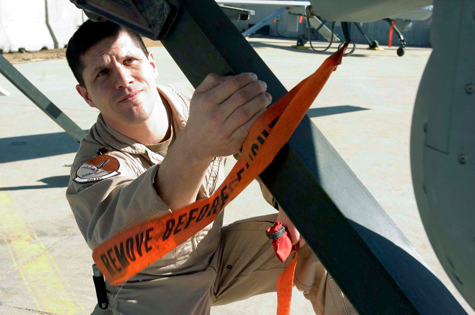 BALAD AIR BASE, Iraq -- Maj. Michael Bruzzini inspects an RQ/MQ-1 Predator unmanned aerial vehicle here.  He is the 46th Expeditionary Reconnaissance Squadron commander (U.S. Army photo by Spc. Leah R. Burton)