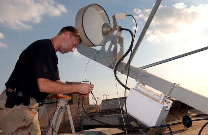 BAGHDAD, Iraq -- Tech. Sgt. Paul Hendrix tests the strength of the satellite signal here Feb. 3.  This satellite system is a satellite hub which receives combat camera imagery from field units throughout Iraq.  Sergeant Hendrix is a video intrusion detection system technician deployed from Charleston Air Force Base, S.C.  (U.S. Air Force photo by Master Sgt. Dave Ahlschwede)