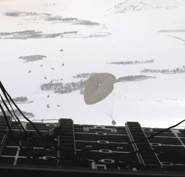 Humanitarian supplies drop from the back of a C-130 Hercules on Feb. 11, 2005, during an Operation Enduring Freedom mission. The C-130 and crew making the airdrop were from the 774th Expeditionary Airlift Squadron at Karshi-Khanabad Air Base, Uzbekistan. (U.S. Air Force Photo/Master Sgt. Scott Sturkol) 