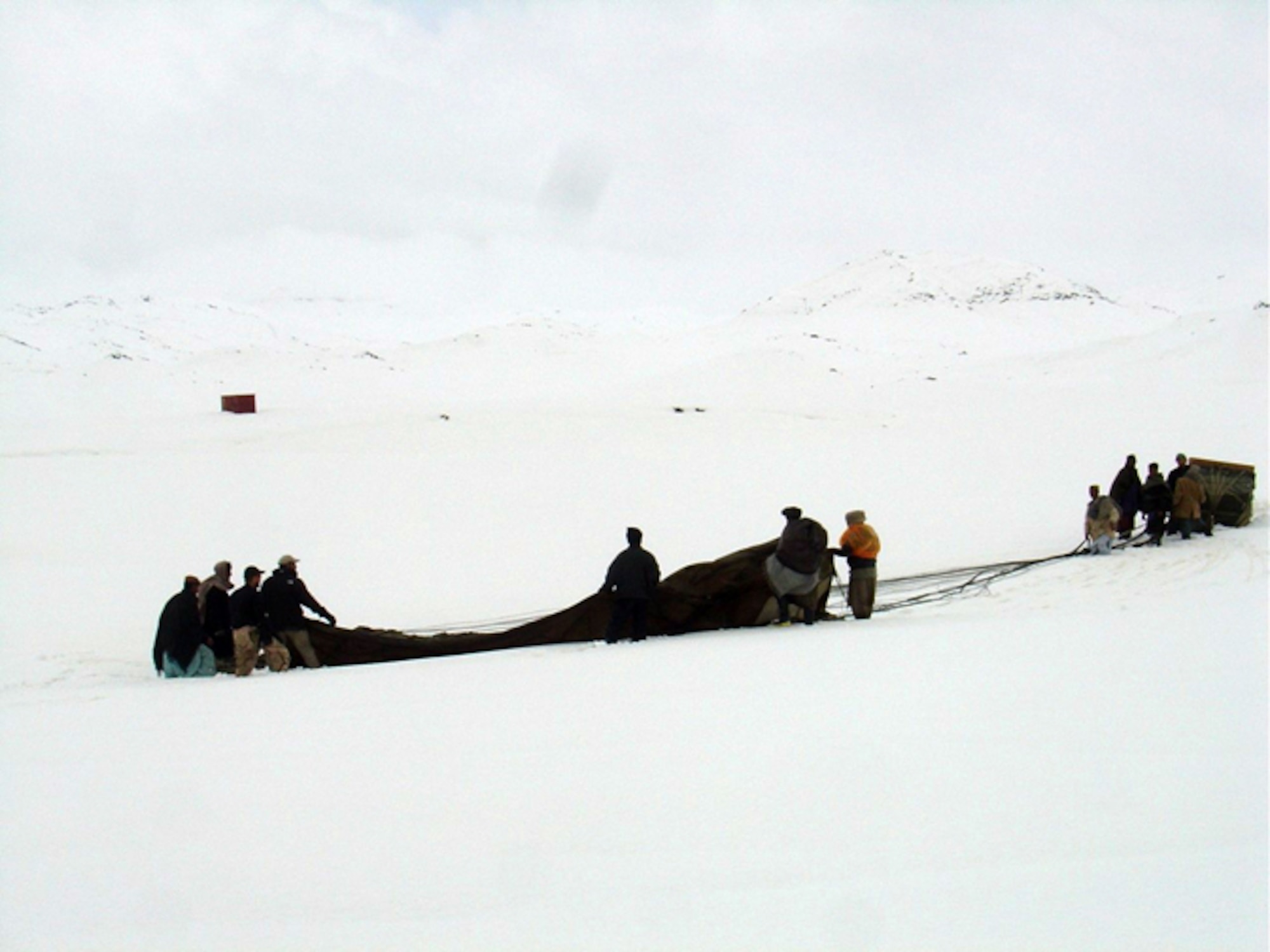 SHIN KAY, Afghanistan -- Residents here receive humanitarian supplies dropped by a C-130 Hercules crew.  (Courtesy photo)
