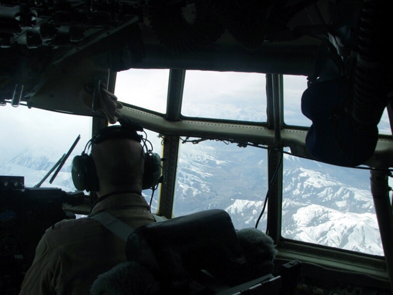 A C-130 Hercules crew flies on a humanitarian airdrop mission over the Afghanistan mountains on Feb. 11, 2005, on the way to Shin Kay, a remote village needing supplies. The C-130 crew was from the 774th Expeditionary Airlift Squadron of the 416th Air Expeditionary Group at Karshi-Khanabad Air Base, Uzbekistan.(U.S. Air Force Photo/Master Sgt. Scott Sturkol) 
