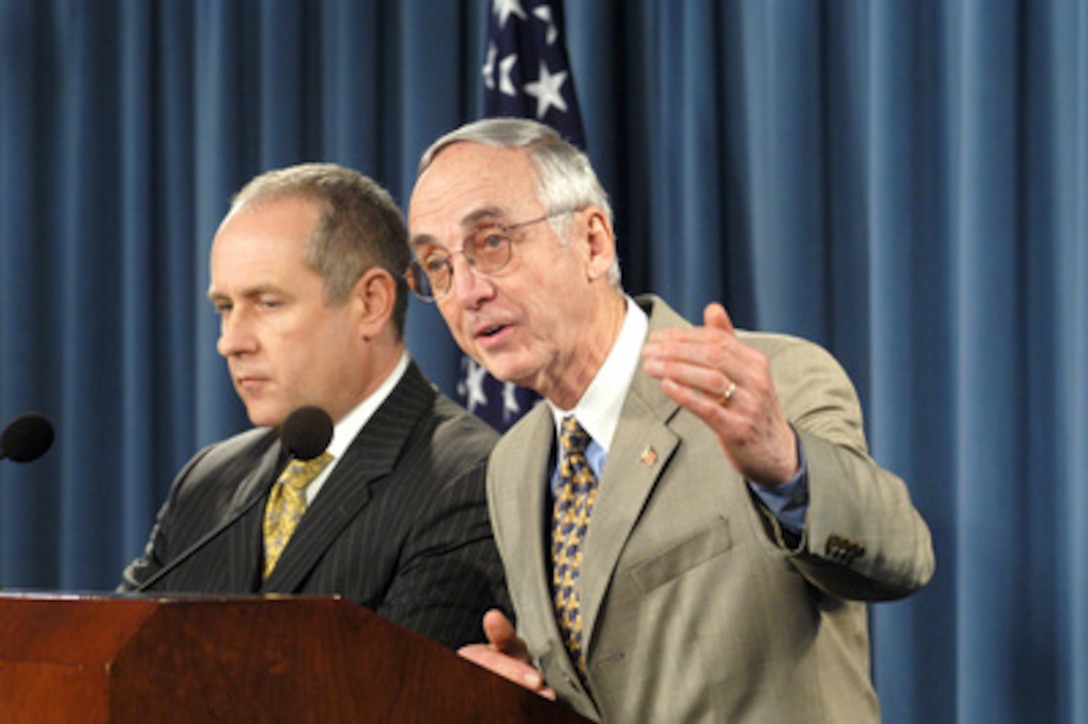 Secretary of the Navy Gordon England (right) and the Acting Director of the Office of Personnel Management Daniel Blair (left) brief reporters in the Pentagon on details of the new National Security Personnel System on Feb. 10, 2005. The proposed regulations will be published in the Federal Register on Feb. 14, 2005. After a period of public comment and Congressional review the finalized regulations are expected to be implemented as early as July of this year. 