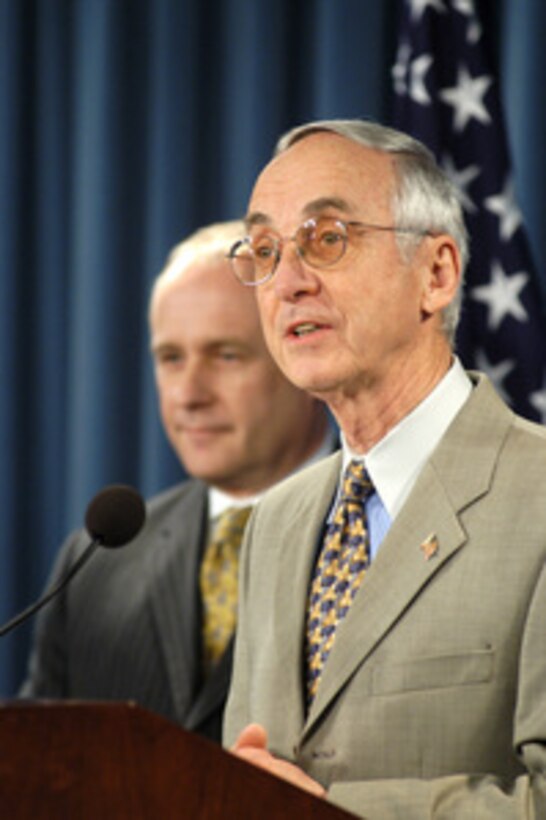 Secretary of the Navy Gordon England (right) and the Acting Director of the Office of Personnel Management Daniel Blair brief reporters in the Pentagon on the details of the new National Security Personnel System on Feb. 10, 2005. The proposed regulations will be published in the Federal Register on Feb. 14, 2005, initiating a 30-day formal public comment period. The final regulations are expected to go into effect as early as July of 2005. 