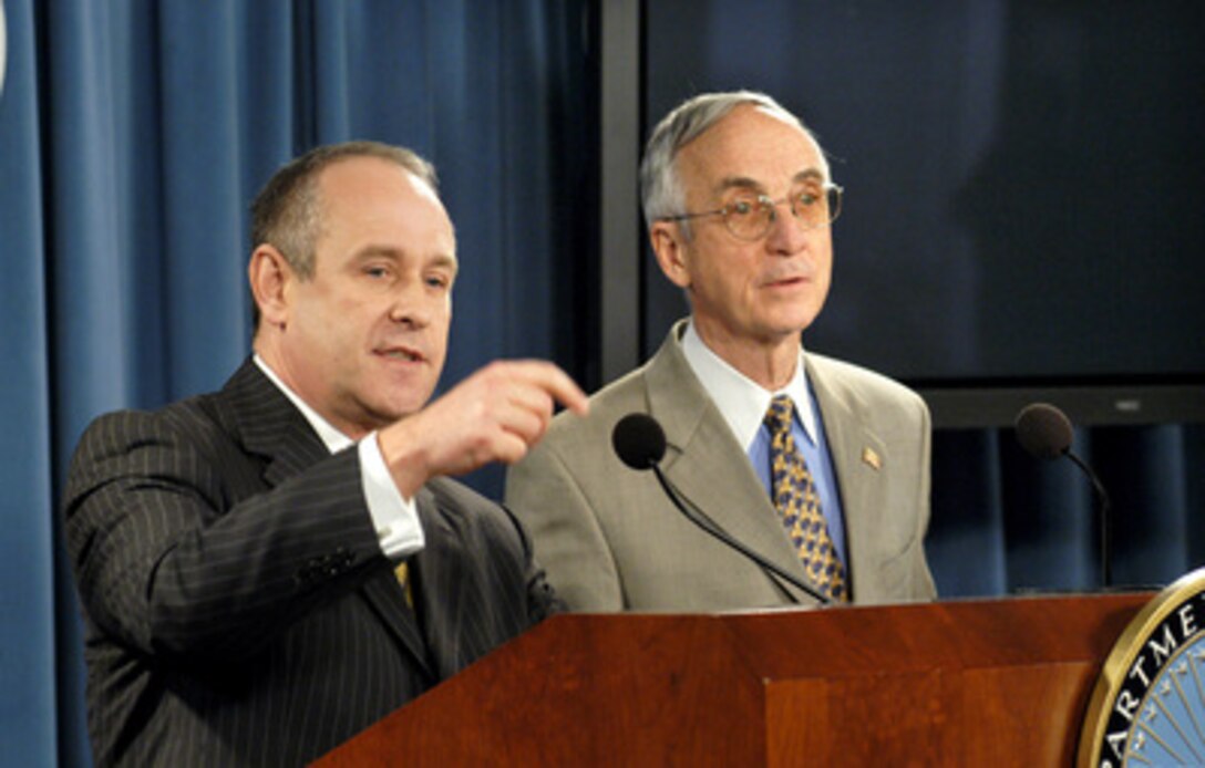 Acting Director of the Office of Personnel Management Dan Blair (left) responds to a reporter's question concerning the new National Security Personnel System during a Pentagon briefing on Feb. 10, 2005. Secretary of the Navy Gordon England (right) also presented details of the new system. The proposed regulations will be published in the Federal Register on Feb. 14, 2005, and after a period of public comment and Congressional review are expected to go into effect July of 2005. 