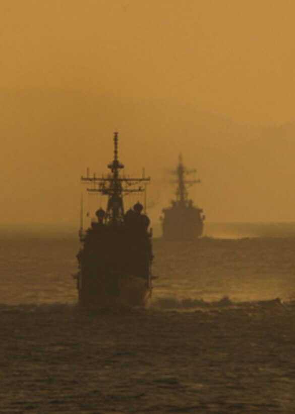 The USS Shiloh (CG-67) and the USS Benfold (DDG-65) fall in line behind the USS Abraham Lincoln (CVN 72) on Feb. 10, 2005. The Lincoln and Carrier Strike Group 9 are deployed to the western Pacific Ocean. 
