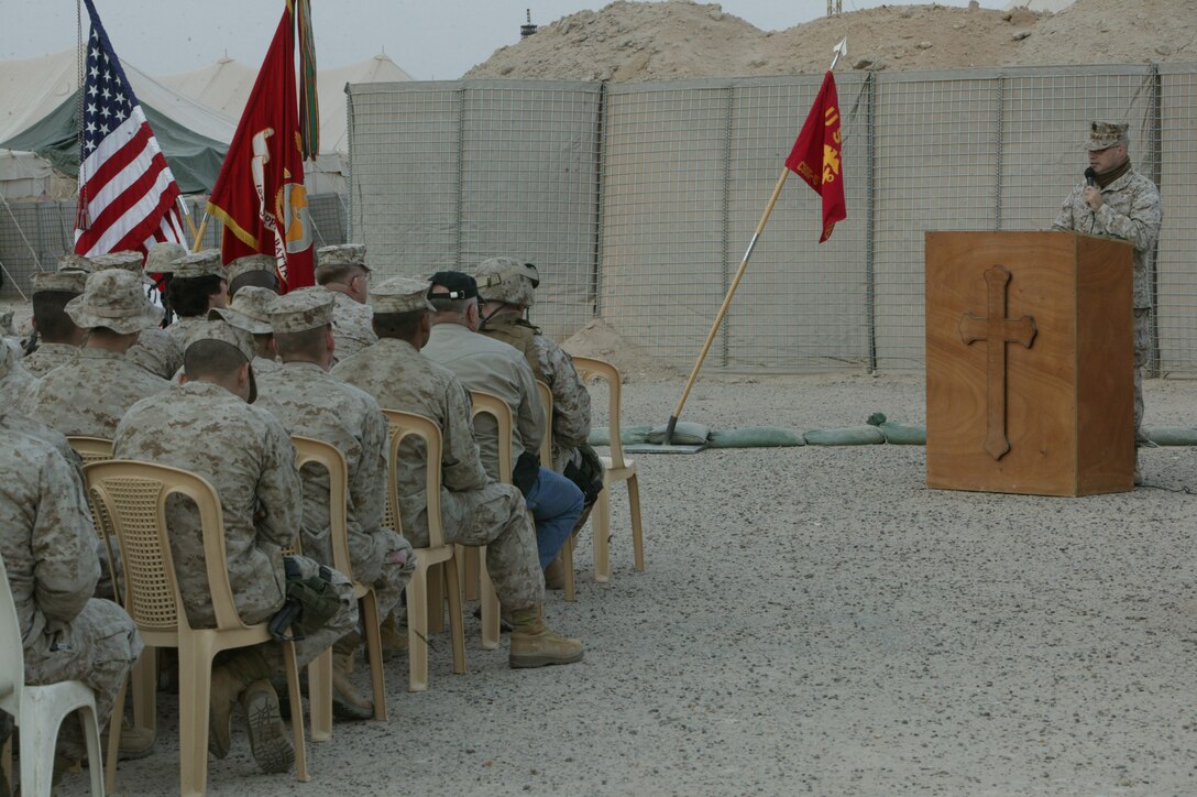 Marines are led in prayer by Lt. j. g. Thomas T. Cook, Combat Service Support Group 15?s chaplain, Feb. 12, 2005, during a memorial service at Camp Taqaddum, Iraq. The Marines of General Support Motor Transport Company, CSSG 15, honored the 19-year-old native of Las Vegas, Nev., for the character he displayed and high standards he held himself to during his life. Perez died conducting operations in support of Operation Iraqi Freedom in Al Anbar Province, Iraq.
