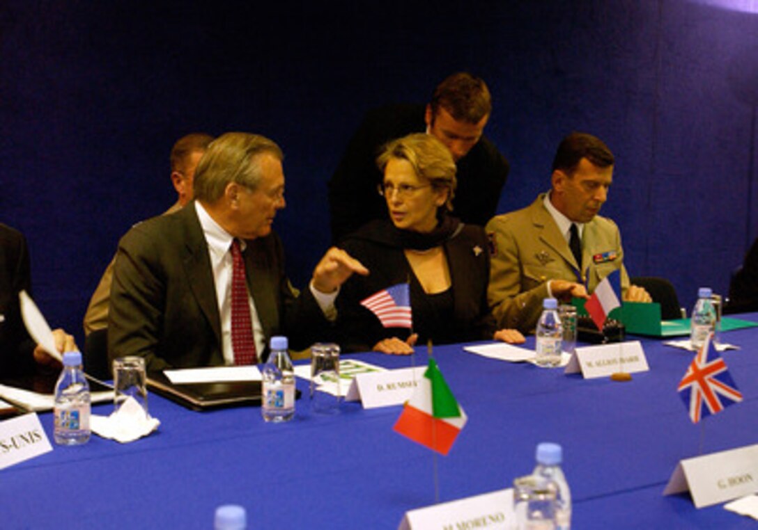 Secretary of Defense Donald H. Rumsfeld (left) and French Minister of Defense Michele Alliot-Marie (center) talk informally before a meeting at the NATO Defense Ministerial Conference in Nice, France, on Feb. 10, 2005. Rumsfeld is in Nice to attend a conference with his NATO counterparts. The alliance defense ministers are meeting to take stock of NATO's transformation and review its operations. 