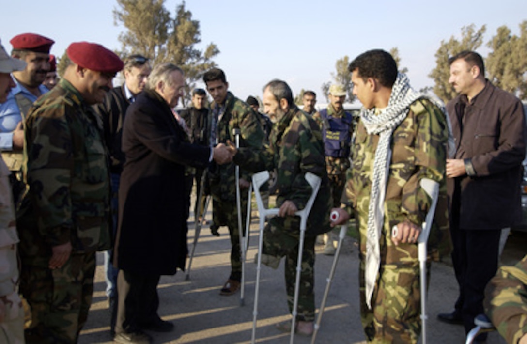 Secretary of Defense Donald H. Rumsfeld shakes hands with members of the Iraqi Special Police Commando unit injured in the line of duty in Baghdad, Iraq, on Feb. 11, 2005. Rumsfeld made an unannounced visit to Iraq to meet with the senior leadership, key government officials and talk to the troops. 