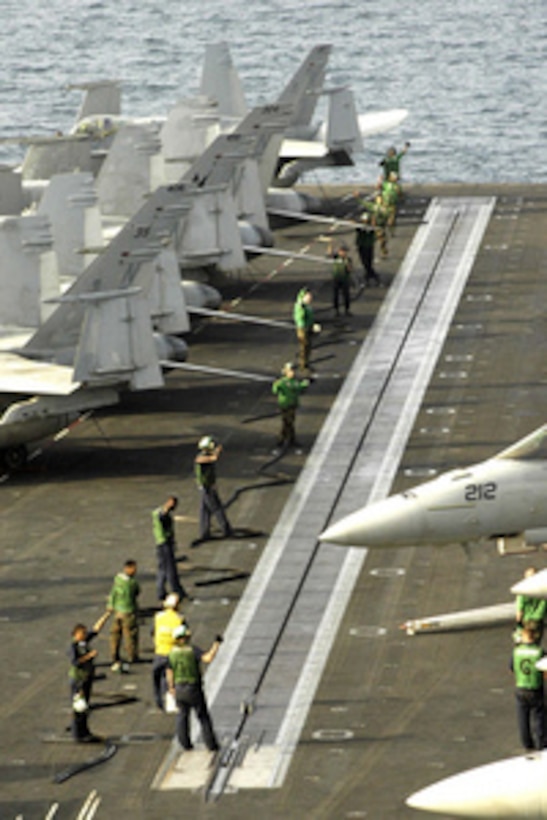 Flight deck personnel conduct a test of the four steam-powered catapults aboard the aircraft carrier USS Abraham Lincoln (CVN 72) at sea on Feb. 11, 2005. Lincoln and embarked Carrier Air Wing 2 are currently underway in the Western Pacific Ocean. 