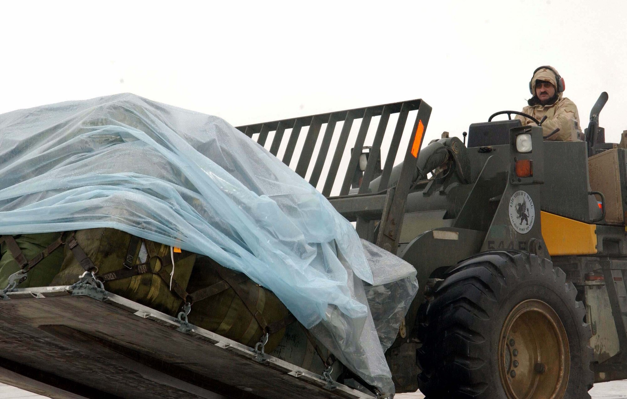BAGRAM AIR BASE, Afghanistan -- Staff Sgt. Robert Willis uses a forklift to move cargo onto a C-17 Globemaster III.  Sergeant Hutchinson is an air transportation specialist with the 455th Expeditionary Logistics Readiness Squadron here, deployed from Dobbins Air Reserve Base, Ga.  (U.S. Air Force photo by Capt. Catie Hague)
