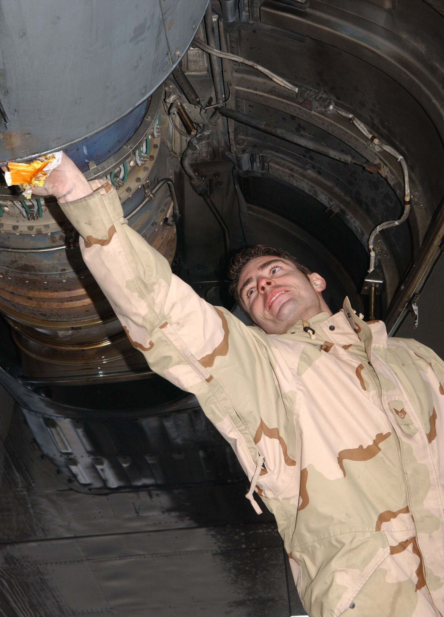 BAGRAM AIR BASE, Afghanistan -- Staff Sgt. Robert King works on the engine of a C-130 Hercules to make sure the aircraft is airworthy.  Sergeant King is assigned to the 455th Expeditionary Logistics Readiness Squadron's transient alert function here, deployed from McChord Air Force Base, Wash.  (U.S. Air Force photo by Capt. Catie Hague)