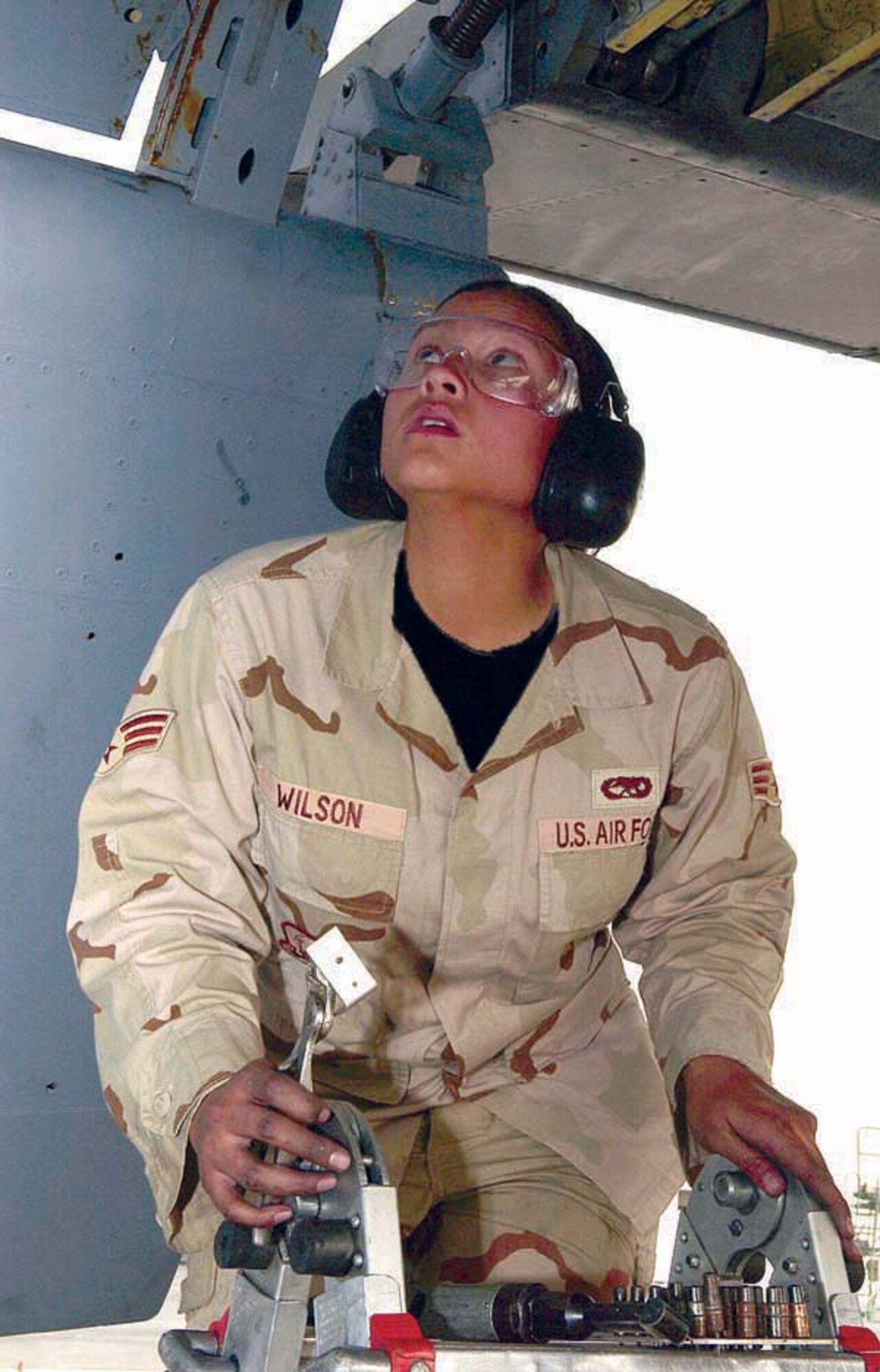 SOUTHWEST ASIA -- Senior Airman Sheri Wilson replaces a cracked support bracket on a KC-135 Stratotanker.  She is an aircraft structural maintenance journeyman assigned to the 379th Expeditionary Maintenance Squadron and deployed from Dyess Air Force Base, Texas.  (U.S. Air Force photo by Staff Sgt. Colette Bennett)
                