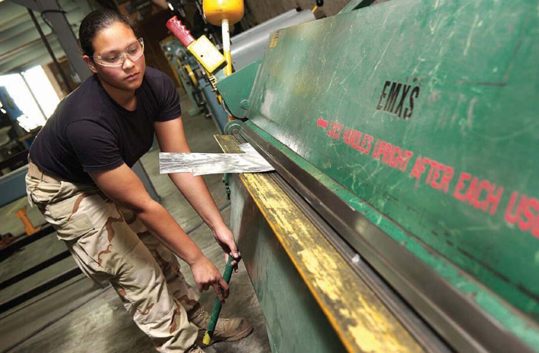 SOUTHWEST ASIA -- Senior Airman Sheri Wilson bends metal for an aircraft repair job at a forward-deployed location here recently.  She is an aircraft structural maintenance journeyman assigned to the 379th Expeditionary Maintenance Squadron and deployed from Dyess Air Force Base, Texas.  (U.S. Air Force photo by Staff Sgt. Colette Bennett)