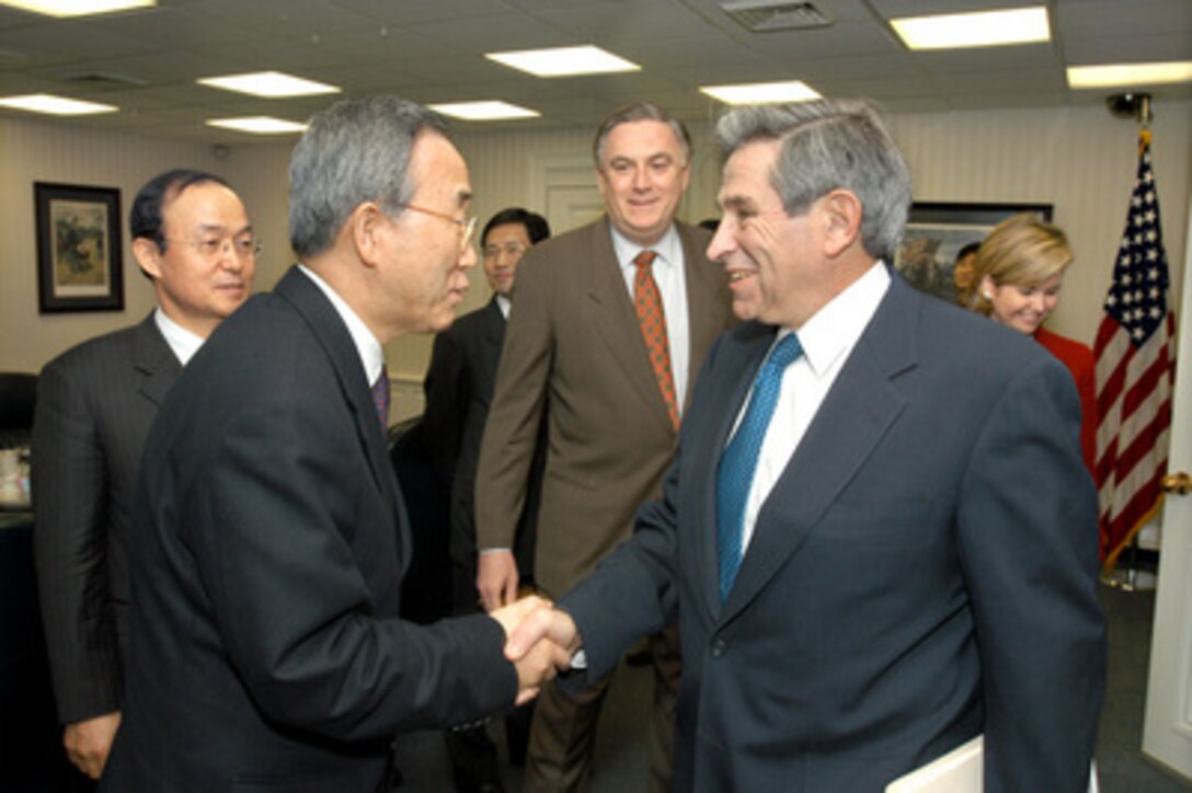 Deputy Secretary of Defense Paul Wolfowitz (right) greets South Korean Minister of Foreign Affairs and Trade Ban Ki- moon (left) in the Pentagon on Feb. 14, 2005. Wolfowitz, Ban and their senior advisors are meeting to discuss bilateral security issues. 