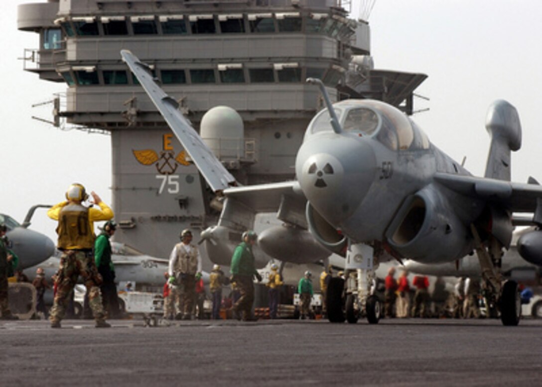 An EA-6B Prowler unfolds its wings as it is directed to a catapult for launch from the flight deck of the aircraft carrier USS Harry S. Truman (CVN 75) on Feb. 4, 2005. The Truman and its embarked Carrier Air Wing 3 is providing close air support and conducting intelligence, surveillance and reconnaissance missions over Iraq. The Prowler is an advanced electronic countermeasures aircraft assigned to the Electric Attack Squadron 130 of Naval Air Station Whidbey Island, Wash. 